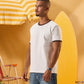 a man wearing an off-white t-shirt with a contrast brown neckline and sleeve trim 