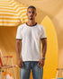 a man wearing an off-white t-shirt with a contrast brown neckline and sleeve trim 