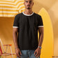 a man wearing a black  t-shirt with contrast white neckline and sleeve trim 