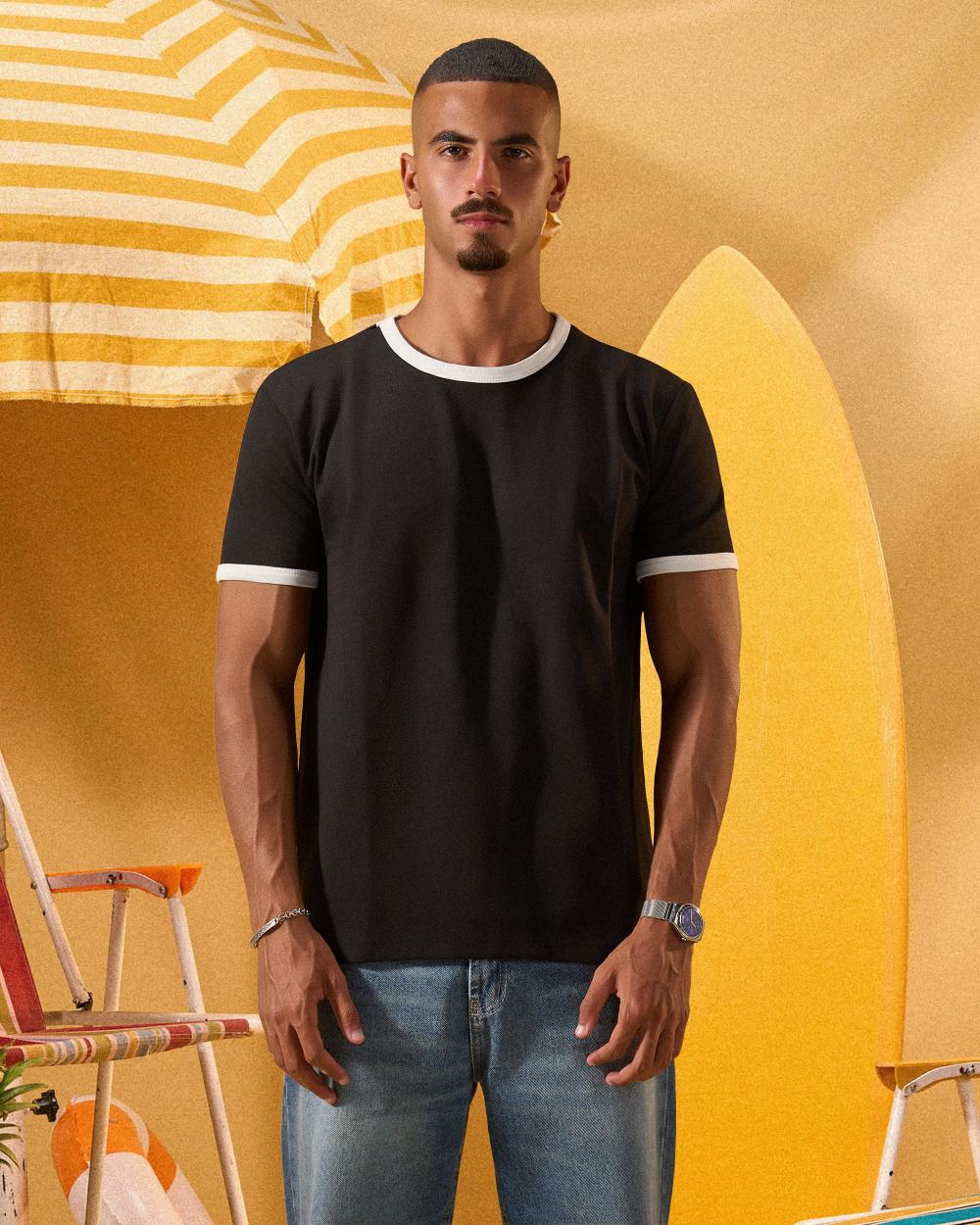 a man wearing a black  t-shirt with contrast white neckline and sleeve trim 