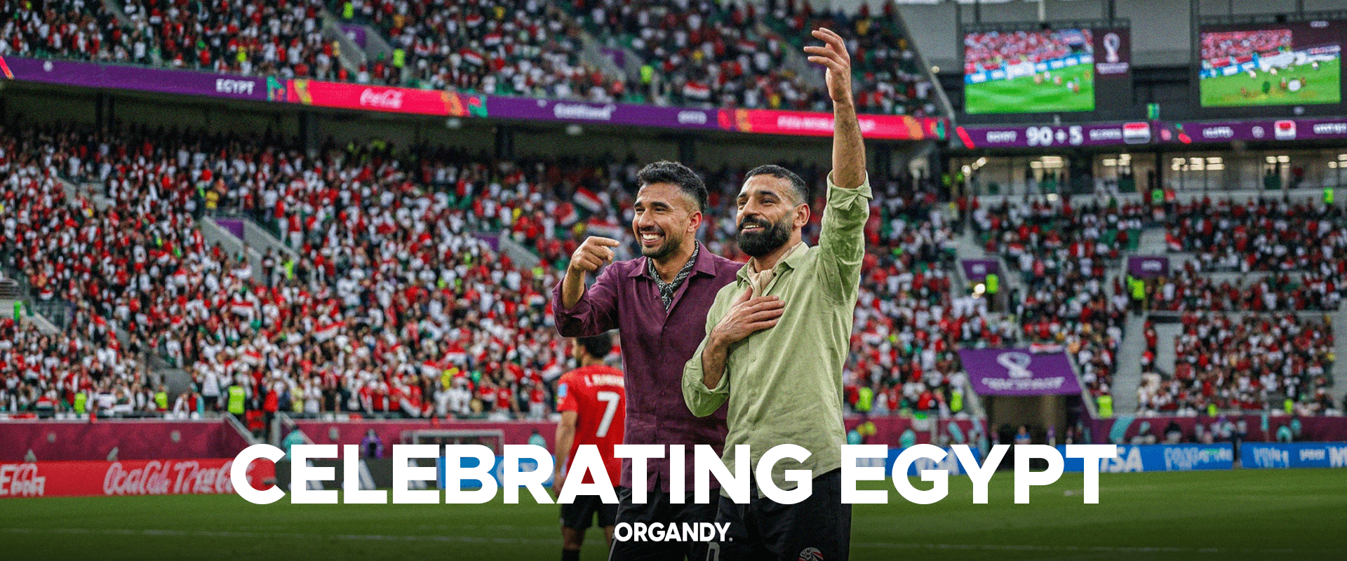 Two men celebrating on a sports field with 'Celebrating Egypt' text and 'Organdy' branding.slider_item_hjrxhC